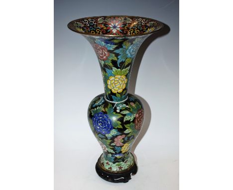 A 20th century cloisonné enamel baluster vase, bird and floral decoration on a black ground, carved wooden base, 40cm high