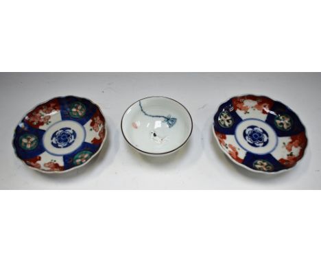 A Chinese miniature bowl, the centre moulded with a Koy Carp in relief; two Chinese saucers (3)