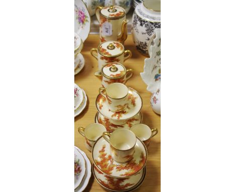 A Japanese Satsuma six-setting coffee set, painted with leafy trees in autumnal tones, gilt and black diaper bands, comprisin