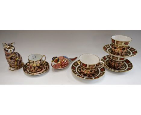 A set of three Royal Crown Derby 1128 pattern tea cups and saucers, first quality; a similar 2451 pattern coffee can and sauc