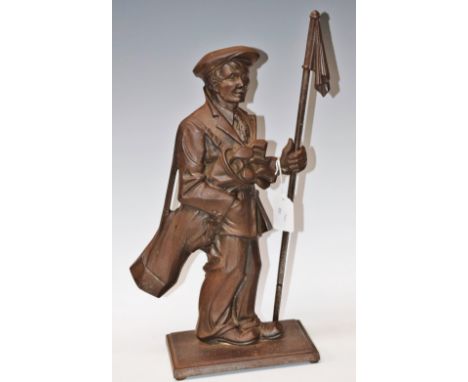 A fireside companion, as a golfer's caddy, carrying his clubs and holding a flagstick marker, approx 43cm high overall