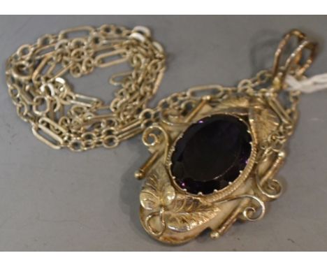 An ornate silver amethyst pendant, on silver neck chain