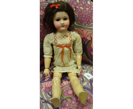 A German bisque head doll, Koppelsdorf, with composite body. brown closing eyes, brown wig, open mouth with teeth, c.1920, 60
