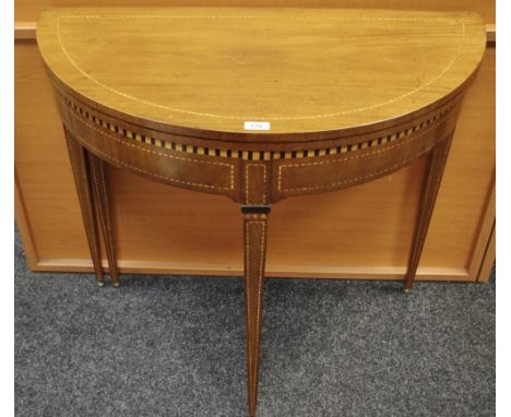 An Edwardian mahogany card table, fold over D top opening to circular green baize playing surface, tapering square legs, cheq