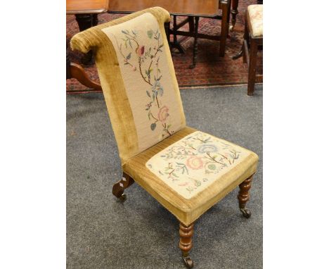 A Victorian mahogany prie-dieu, floral wool work back and seat, turned forelegs and ceramic castors