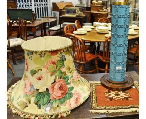 A mid 20th Century table lamp, columnar form, applied  decoration, on turned wooden base; a small woollen rug, autumnal colou