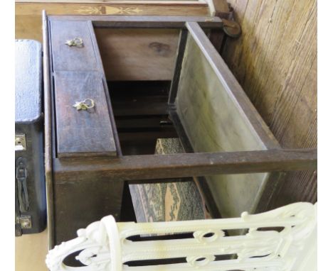 An oak table trolley, the top with hinged flap over two frieze drawers, a shelf and castors, 78cm wide
