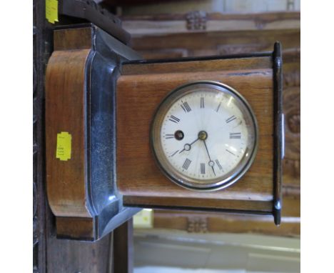 A late Victorian walnut and ebonised mantel clock, with shaped front and enamelled dial, single train French movement, 21cm h