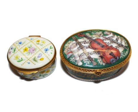 An enamel pill box by Crommles with floral decoration together with a Royal Worcester pill box 'If Music Be The Food Of Love'