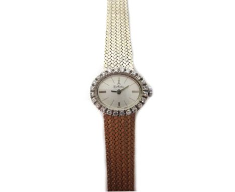 A lady's white gold and diamond set La Martine bracelet wristwatch, the oval silvered dial with baton shaped numerals, the be
