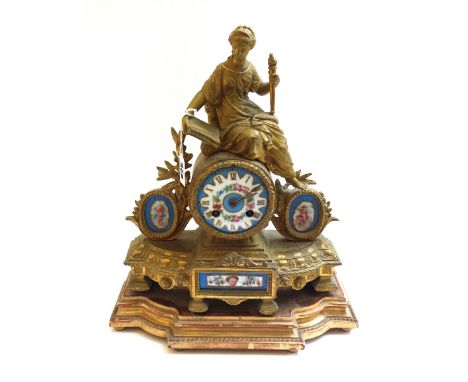 A French gilt metal figural mantel clock, late 19th century, with painted porcelain dial and matching inset porcelain plaques