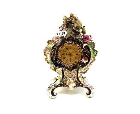 A porcelain mantel clock, possibly Coalport, circa 1830, decorated with applied fauna and flora, 34cm high. 