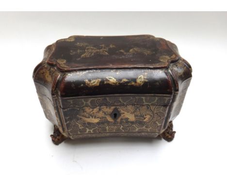 An early Victorian black lacquer chinoiserie decorated tea caddy of shaped compressed octagonal form, with twin lidded pewter