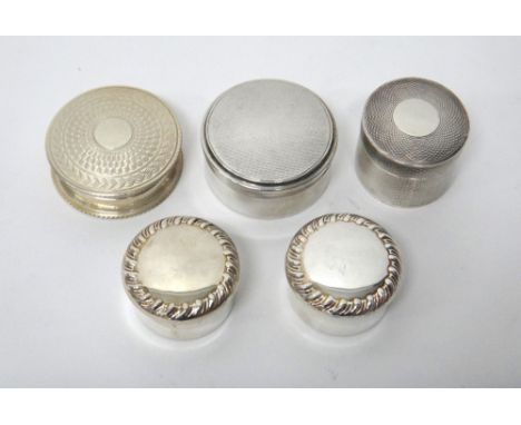 A pair of silver circular boxes, each decorated with a fluted rim, Birmingham 1910, a silver circular box, having engine turn