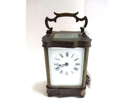 A brass cased carriage clock, late 19th century, with shaped case, white enamel dial and a single train movement on four circ