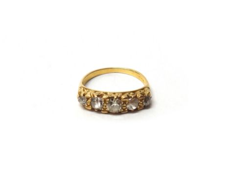 A gold and diamond set five stone ring, mounted with a row of cushion shaped diamonds graduating in size to the centre stone,