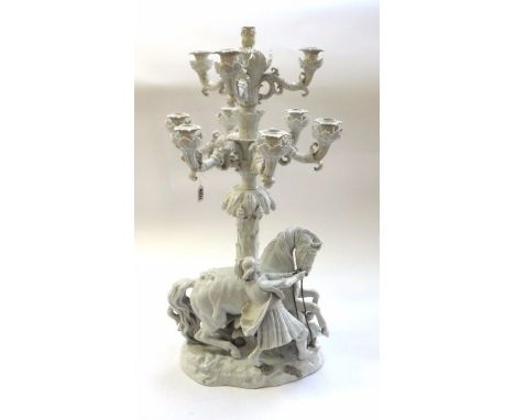 A large German Thuringian porcelain ten light figural candelabrum, late 19th century, the base modelled with a man tethering 