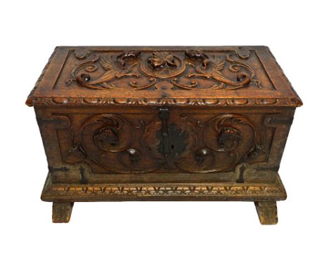An 18th century Italian oak coffer, carved in high relief, the lid centred with a portrait mask, possibly of Augustus, flanke