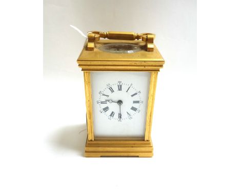 A gilt brass cased carriage clock, 20th century, the white enamel dial detailed with Roman numerals, with two train movement,