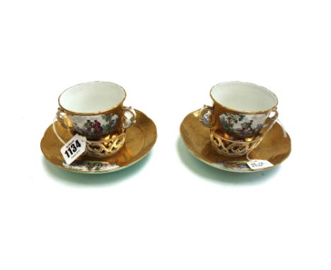 Two Berlin porcelain trembleuese two handled cups and saucers, late 19th century, each decorated with cartouches of hunting s
