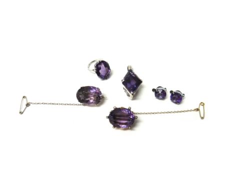 A gold brooch, claw set with an oval cut amethyst, in a surround of six seed pearls, a silver and amethyst set single stone b