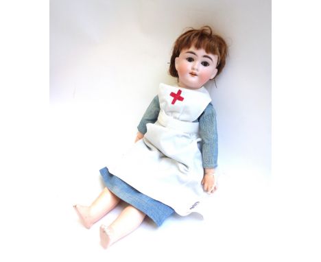 A Max Handwerck bisque head doll, Germany 2 1/4, with brown wig, sleep eyes, open mouth and composite jointed body, wearing a