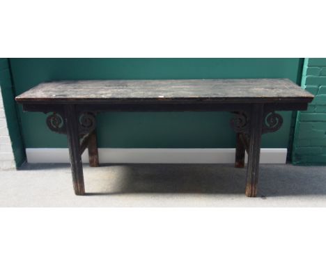 A late 19th century Chinese ebonised altar table, on block supports, mounted with pierced scroll brackets, 205cm wide.