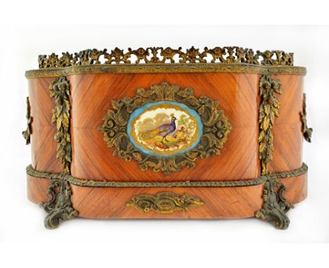 A 19th century French gilt metal and ceramic mounted kingwood jardiniere of serpentine outline, 50cm wide.  Illustrated