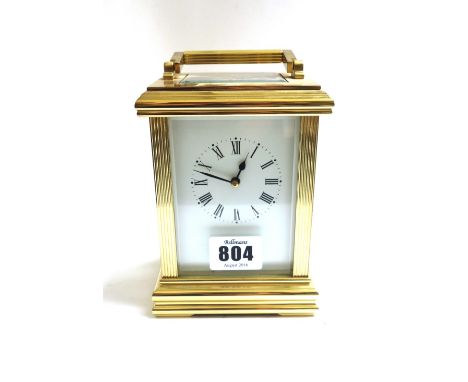 A gilt brass cased carriage clock, late 20th century, the white enamel dial flanked by reeded supports, on a plinth base, wit