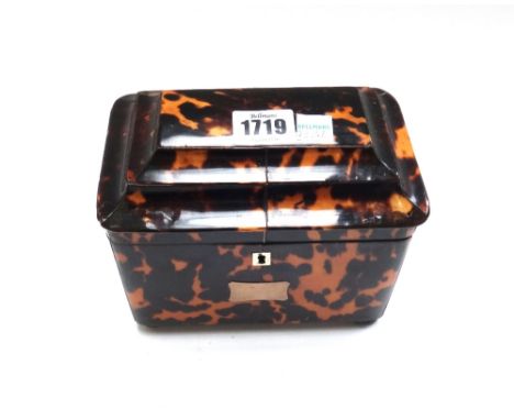 A George III tortoiseshell tea caddy, with twin lidded interior on metal bun feet, 17cm wide.