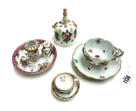 A Meissen floral encrusted tea cup and saucer, 20th century, together with a similarly decorated Meissen porcelain hand bell,