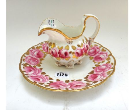 A Victorian matched part tea service decorated with roses against a gilt white ground, comprising; a milk jug, a sugar bowl, 