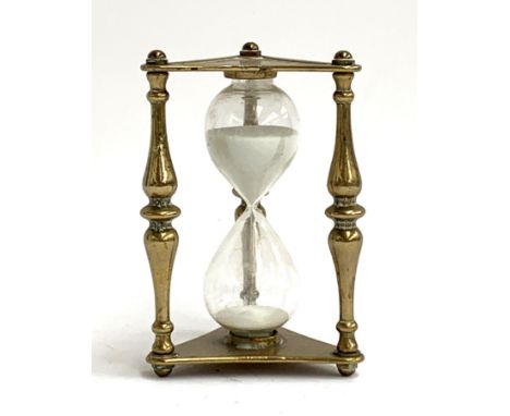 An antique egg timer in triangular brass case, 15.5cmH 