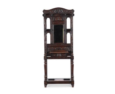 A carved oak hall stand in antiquarian taste late 19th or early 20th century 187cm high, 76cm wide, 36cm deep