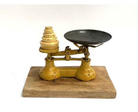 A set of Lewis's 7lb vintage kitchen scales with weights, together with a chopping board 