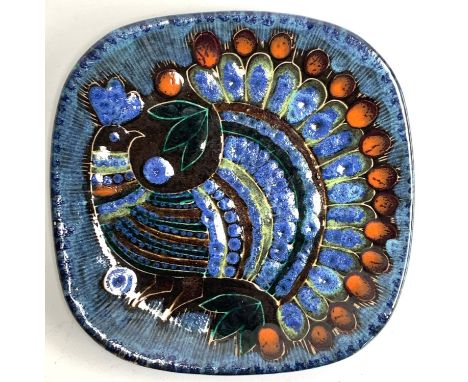 A Marjatta Taburet Quimper dish depicting a peacock, marked to base HB Quimper, 1974, 24.5cmW 