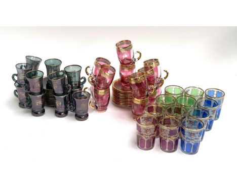 A quantity of coloured and gilt glassware to include tea glasses, coloured tumblers, saucers etc 