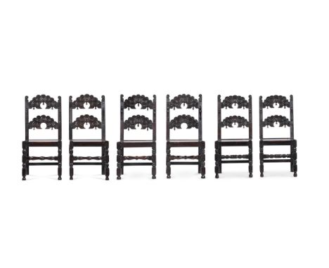 A set of six carved oak chairs in 17th century style late 19th or early 20th century variously bearing paper and enamel label