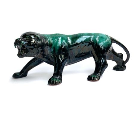 A large glazed Poole pottery style statue of a roaring lion, 62cmW 