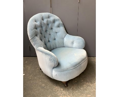 A small Victorian buttonback salon chair, turned legs and ceramic casters 