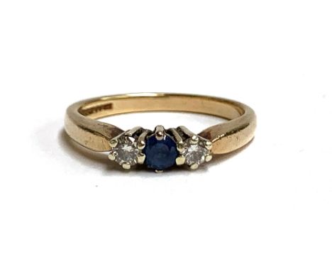 A 9ct gold ring set with diamonds and a sapphire, size N, approx. 2.7g 