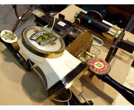 Three vintage beer pumps including Greenall's