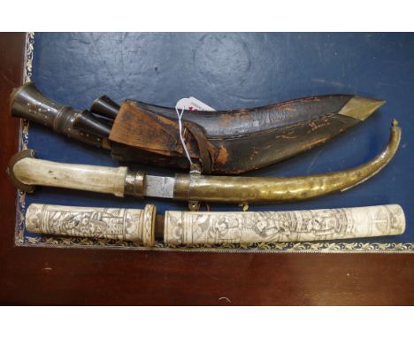 A horn handled kukri and sheath; together with a Japanese bone handled dagger and sheath; and an Arab bone handled Jambiya an