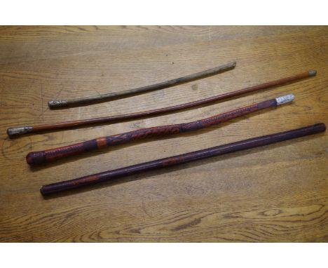 A Royal Sussex Regiment swagger stick;&nbsp;together with a silver mounted malacca example; and two further leather covered s