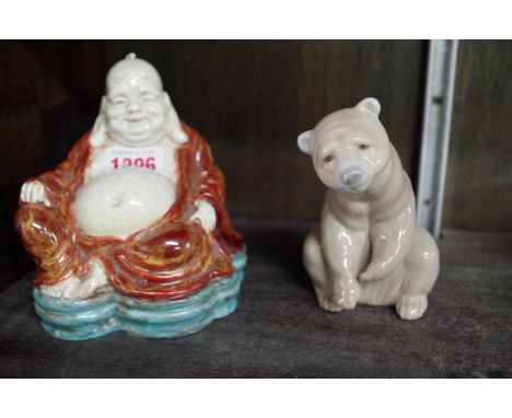 A Chinese pottery Buddha,&nbsp;13.5cm high;&nbsp;together with a Lladro bear, 11.5cm high. 