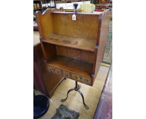 An unusual&nbsp;early 20th century oak and steel tripod bookcase Canterbury,&nbsp;the drawers with electroplated handles, 50c