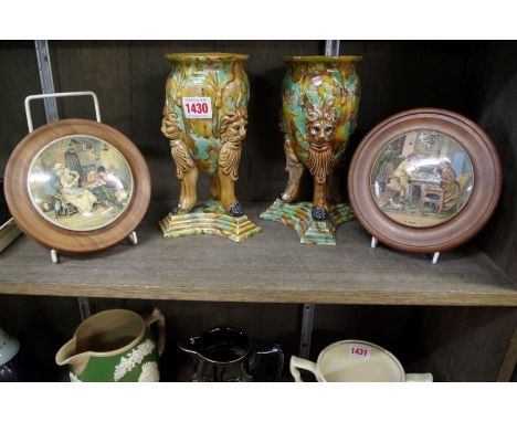 A pair of majolica tripod vases,&nbsp;20cm high; together with two Victorian pot lids.&nbsp; 
