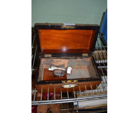 A 19th century tea caddy in the form of a treasure chest containing three silver spoons and a silver vesta