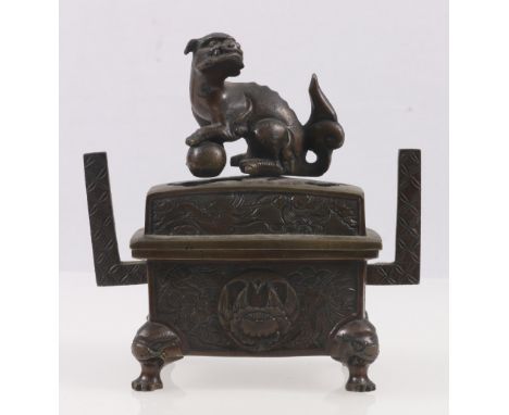 Bronze censor of rectangular section, with liner, the pierced lid with lion dog finial, upswept straight handles, the body de