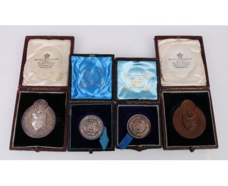 Three silver cycling medals, awarded to D H Huie, comprising two 1884 National Cycling Union boxed medalions and an Edinburgh